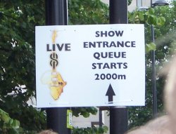 [A sign saying 'Show Entrance Queue Starts 2000m']