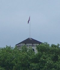 [Union Jack flag flying over Buckingham Palace]