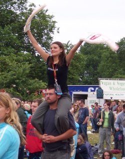 [Same woman as previous picture, now sat on someone else's shoulders]