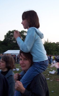 [Young girl sat on her mother's shoulders]